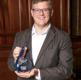 Wesley Combs holding a business journal healthcare hero's award